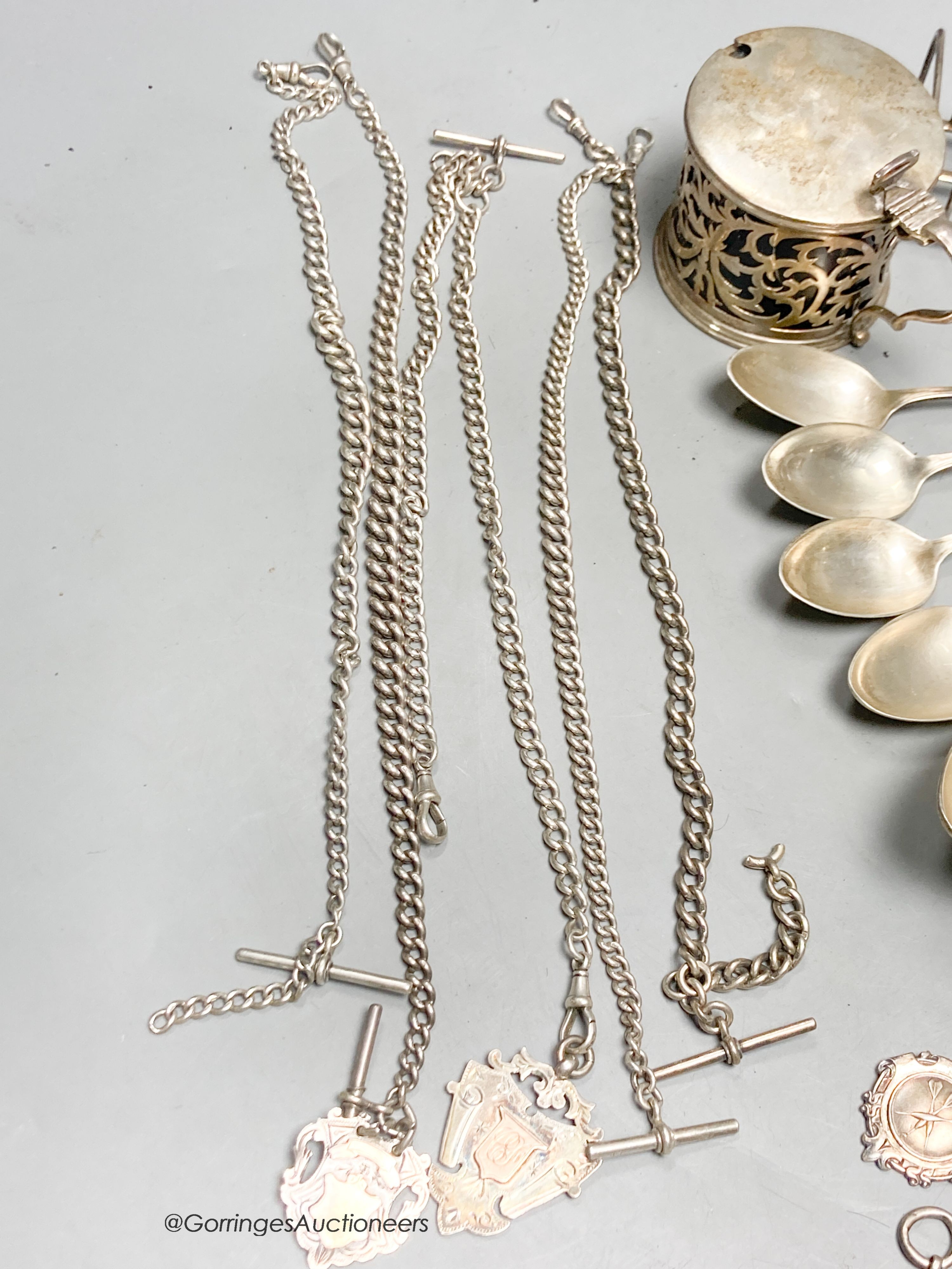 A collection of small silver, including a George V silver mustard, continental white metal and English silver flatware, toastrack, salt, inkwell etc. and a plated candlestick.